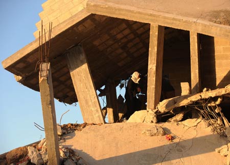 Photo taken on January 27, 2009 shows a partial view of the houses of Mahamad Abd Raabo in Jibaliya, northern Gaza Strip. The two-floor building which costed 18-year hard work of Abd Raabo was damaged during Israeli military attacks. Abd Raabo and his wife are unwilling to leave and still living in it. [Xinhua]