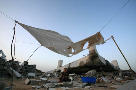 A Palestinian sits in the rubbles in al Moghraqa area in the central Gaza Strip, on January 29, 2009.