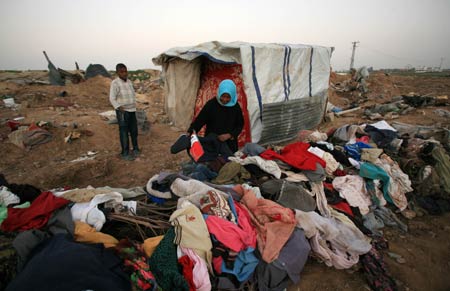 Palestinians live in the rubbles in al Moghraqa area in the central Gaza Strip, on January 29, 2009.