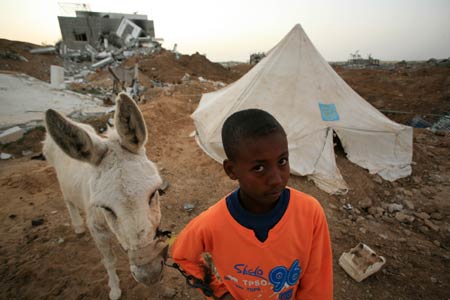 A Palestinian child stands in the rubbles in al Moghraqa area in the central Gaza Strip, on January 29, 2009.