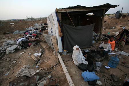 Palestinians live in the rubbles in al Moghraqa area in the central Gaza Strip, on January 29, 2009.