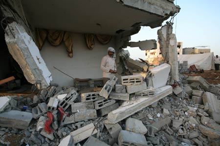 A Palestinian stands in the rubbles in al Moghraqa area in the central Gaza Strip, on January 29, 2009.