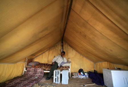 A Palestinian rests in a tent in al Moghraqa area in the central Gaza Strip, on January 29, 2009.