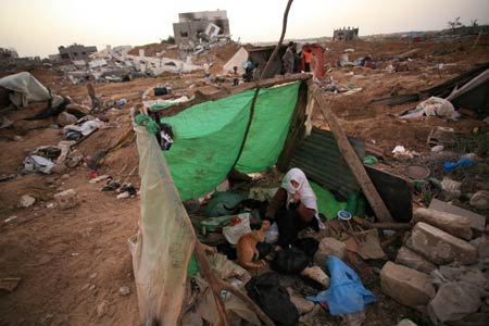 Palestinians live in the rubbles in al Moghraqa area in the central Gaza Strip, on January 29, 2009.