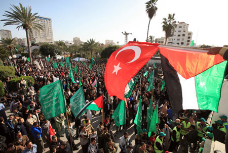 A Turkish national flag (red, top) is seen during a rally held by supporters of Hamas in Gaza City, on January 30, 2009. Turkey's Prime Minister Tayyip Erdogan got praise from Palestinians after he stormed out of the debate with President of Israel Shimon Peres in the session 'Gaza: The Case for Middle East Peace' at the Annual Meeting 2009 of the World Economic Forum in Davos of Switzerland on Thursday.