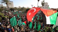 A Turkish national flag (red, top) is seen during a rally held by supporters of Hamas in Gaza City, on January 30, 2009. Turkey's Prime Minister Tayyip Erdogan got praise from Palestinians after he stormed out of the debate with President of Israel Shimon Peres in the session 'Gaza: The Case for Middle East Peace' at the Annual Meeting 2009 of the World Economic Forum in Davos of Switzerland on Thursday.