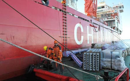 Members of Chinese expedition team unload floor slabs from China&apos;s Antarctic ice breaker Xuelong, or Snow Dragon, on January 29, 2009. 
