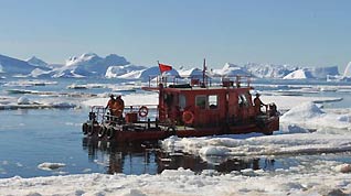 Huanghe Boat returns to China's Antarctic ice breaker Xuelong, or Snow Dragon, from Panda Dock of Zhongshan Antarctic Station after unloading goods, on January 29, 2009. As glaciers clears off, ice breaker Xuelong began unload goods to Zhongshan Antarctic Station.