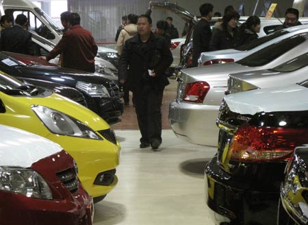 Visitors check cars in an auto trade market in Beijng, capital of China, on January 30, 2009. Many Chinese chose Spring Festival holidays to select and buy cars as the central government released automotive industry boosting plan in the middle of January.