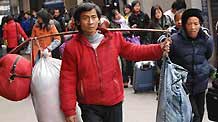 A migrant worker, with luggages on his shoulder, walks out of Hangzhou Railway Station in Hangzhou, east China's Zhejiang Province, on January 30, 2009. As the Spring Festival holiday is about to finish, passenger transportation of the Spring Festival started to reach the peak of return passengers.