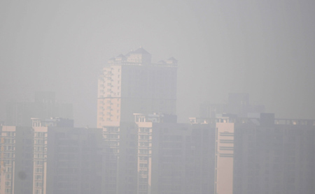 Heavy fog covers the buildings in Wuchang district of Wuhan, capital of central China's Hubei Province, on January 31, 2009. Foggy weather will continue in most of east and central China for three days and is likely to affect the travel rush after the Spring Festival, said the National Meteorological Center (NMC) on Friday.