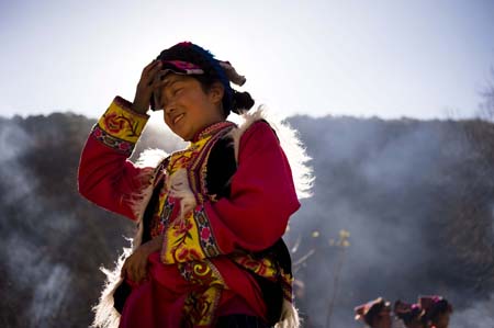 Eleven-year-old Chen Guoting, a girl of the Qiang ethnic group takes part in activities held in Qugu township of Maoxian County, southwest China's Sichuan Province, on January 30, 2009. The Qiang people in Maoxian celebrate the first Spring Festival after the tragic quake in Sichuan with full hope.