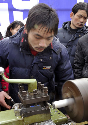 A migrant worker shows his operating skills during a job fair held in Wuhu, east China's Anhui Province, on January 31, 2009. There were lots of job fairs held, providing job opportunities to migrant workers at the end of the Spring Festival holidays, in different places of Anhui Province, one of the main sources of migrant workers in China.