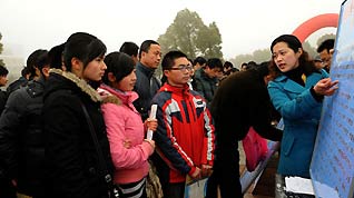 A working staff introduces job information to jobseekers during a job fair held in Lu'an, east China's Anhui Province, on January 31, 2009. There were lots of job fairs held, providing job opportunities to migrant workers at the end of the Spring Festival holidays, in different places of Anhui Province, one of the main source of migrant workers in China.