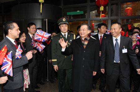 Chinese Premier Wen Jiabao (2nd R Front) meets with staff members of Chinese financial institutions in Britain at the Bank of China (Britain) Co. Ltd. in London on January 31, 2009. Chinese Premier Wen Jiabao arrived in London on January 31 for a three-day visit to Britain.