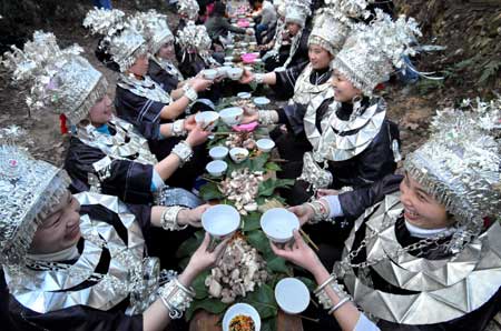 Women of Miao ethnic group toast at a diner in the Zhanliu Village of Jianhe County, southwest China's Guizhou Province, on January 31, 2009.