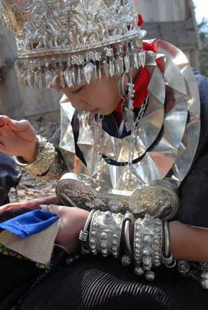 A girl of Miao ethnic group makes embroidery in the Zhanliu Village of Jianhe County, southwest China's Guizhou Province, on January 31, 2009.