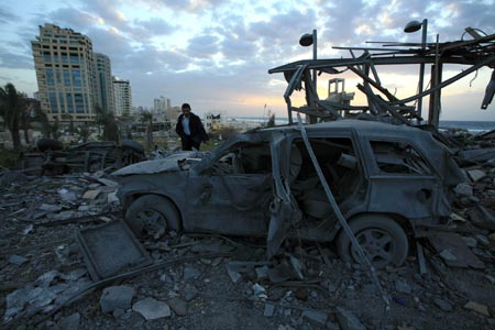 A security member of the Palestinian Islamic Resistance Movement (Hamas) inspects the debris of the presidential office in Gaza City, Jan. 31, 2009. The compound, used to be the residence of late Palestinian leader Yasser Arafat, was razed to the ground during Israel's 22-day operation of Cast Lead against the Gaza Strip.