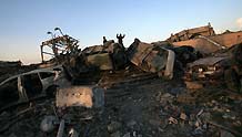 Security members of the Palestinian Islamic Resistance Movement (Hamas) inspects the debris of the presidential office in Gaza City, on January 31, 2009. The compound, used to be the residence of late Palestinian leader Yasser Arafat, was razed to the ground during Israel's 22-day operation of Cast Lead against the Gaza Strip.