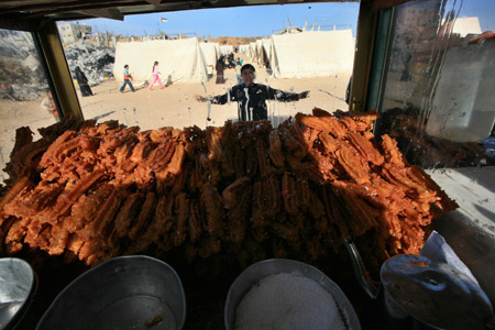 A boy stands by a cart selling sweets at a camp of Palestinians who lost their homes during the 22-day Israeli offensive in Jabalia, northern Gaza Strip, on January 31, 2009.