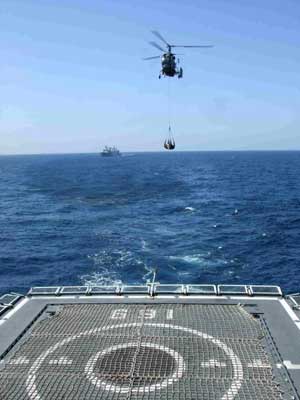 A helicopter with supplies flies towards the Chinese destroyer Wuhan sailing in the Gulf of Aden, on January 31, 2009.