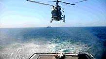 A helicopter unloads supplies onto the deck of Chinese destroyer Wuhan sailing in the Gulf of Aden, on January 31, 2009. The destroyer Wuhan sent a helicopter to fetch supplies from a Chinese merchant ship Xin Fei Zhou on Saturday, which was the first vertical replenishment (VERTREP) done by the Chinese naval fleet since it began its escort mission against pirates on January 6, 2009.