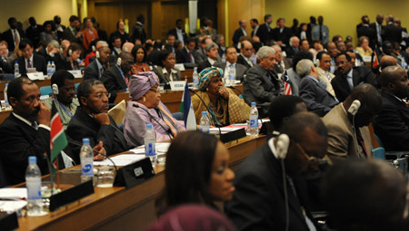 Delegates react during the opening ceremony of the 12th AU summit at the conference center of the United Nations' Economic Commission of Africa(ECA) in Addis Ababa, capital of Ethiopia, on February 2, 2009. 