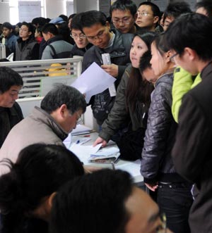 Jobseekers inquire about job information at a job fair held in Hangzhou, east China's Zhejiang Province, on February 3, 2009. Various job fairs were held all over China after the Spring Festival to provide job opportunities for migrant workers, new graduates and laid-offs.