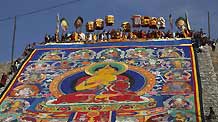 Ethnic Tibetan monks display a giant 'thangka', a sacred painting on cloth on a hill outside a monastery in Tongren, northwest China's Qinghai Province on Monday, on February 2, 2009. Local Tibetan monks and pilgrims gather to celebrate Monlam, or Great Prayer Festival, one of the most important festivals in Tibetan Buddhism.