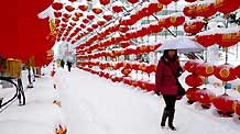 A woman walks in snow in Altay, northwest China's Xinjiang Uygur Autonomous Region, on February 3, 2009. A heavy snowfall hit Altay area Tuesday, causing inconvenience to traffic.