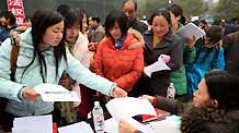 People seek for job information at the job fair for migrant workers held in Zhijiang City, central China's Hubei Province, on February 3, 2009. Some 3,100 job vacancies were provided to migrant workers at the job fair.