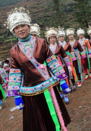 Girls of Miao ethnic group dance in the Hongshui Village of Rongshui Miao Autonomous County, southwest China's Guangxi Zhuang Autonomous Region, on February 4, 2009, the Spring Begins, first of the 24 solar terms in China's lunar calendar. Residents of Miao ethnic group celebrated the Begin of Spring by various activities, such as Lusheng (a reed-pipe Bamboo-cluster flute) Dance and Lusheng blowing on Wednesday.