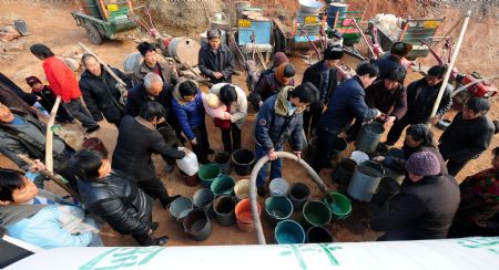 People barrel drinking water supplied by the local government at Chengguan Township in Ruyang County of Luoyang City, central China's Henan Province, on February 4, 2009. The city had received a reduced effective rainfall since October 2008, almost 80 percent less than in the same period of previous years. The local government has allocated some 25 million yuan (US$3.65 million) for drought relief and crops protection.