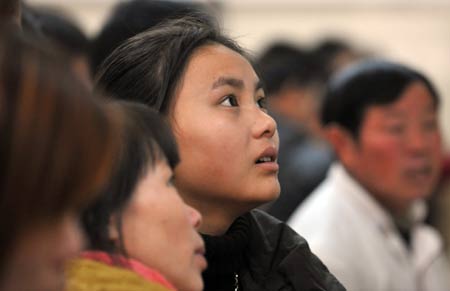 Female migrant workers look at job information in the Hangzhou Migrant Labour Force Market for jobs in Hangzhou, capital of east China's Zhejiang Province, on February 5, 2009. According to statistics of the market, the number of migrant workers looking for jobs in Hangzhou after the traditional Chinese Spring Festival is at the same level with those in 2008.