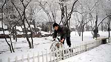 A man plays with snow in Taiyuan, capital of north China's Shanxi Province, on February 8, 2009. A snowfall hit Taiyuan on Sunday.