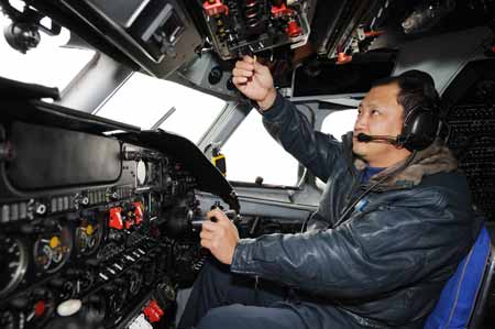 Captain Huo Qishu pilots the aircraft 'Transport 7' on the mission of artificial rainfall operations in Zhengzhou, capital of central China's Henan Province, February 8, 2009. A couple of 'Transport 7' aircraft of China's Air Force performed artificial rainfall operations in Huaibei of east China's Anhui Province, and Luoyang and Kaifeng of central China's Henan Province separately to relieve local drought on Sunday.