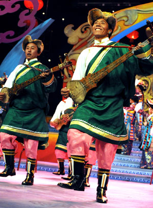 Tibetan farmers perform during a dress rehearsal of the evening party held by Lhasa TV station for the upcoming new year of Tibetan calendar which falls on February 25, in Lhasa, capital of southwest China's Tibet Autonomous Region, on February 10, 2009. 