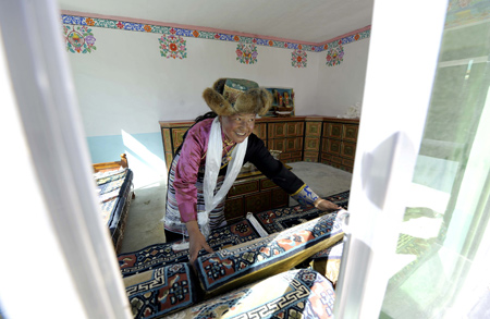 A Tibetan villager stands in her new house in Kunggar Town of Maizhokunggar County in Lhasa, capital of southwest China's Tibet Autonomous Region, on February 11, 2009. 