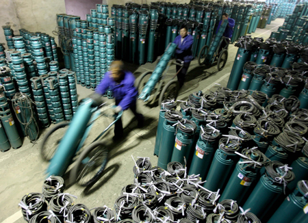 Workers transport pumps in the workshop of a pump company in Yuncheng, north China's Shanxi Province, on February 12, 2009. The local pump company expanded production to meet the urgent need of the drought areas in China such as Henan, Hebei, Shanxi and Shandong provinces.