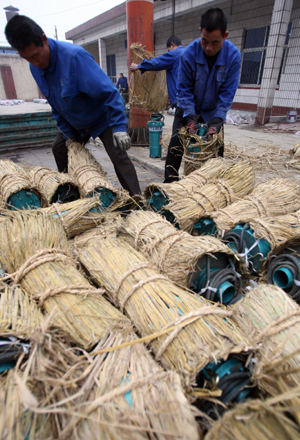 Workers load pumps in a pump company in Yuncheng, north China's Shanxi Province, on February 12, 2009.