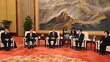 Wang Zhaoguo (2nd R), who is a member of the Political Bureau of the Communist Party of China (CPC) Central Committee, vice chairman of the Standing Committee of the Chinese National People's Congress (NPC) and also the chairman of the All-China Federation of Trade Unions (ACFTU), meets with delegates who attend the 2009 International Forum on Economic Globalization and Trade Unions, in Beijing, capital of China, on February 12, 2009.