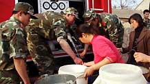 Soldiers help the villagers to get water from a fire engine in Lieshan Township in Huaibei City, east China's Anhui Province, February 12, 2009. Fire engines were sent to deliver water for residents in the villages of Lieshan Township. Huaibei City has suffered from drought since October last year.