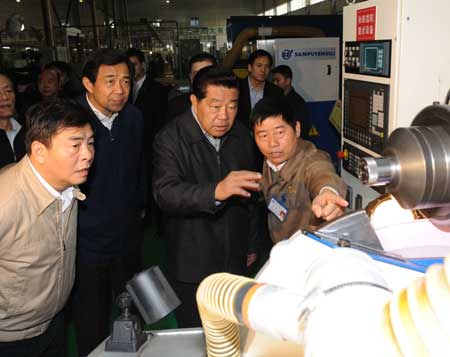 Jia Qinglin (2nd R, front), chairman of the National Committee of the Chinese People's Political Consultative Conference, inspects Zongshen Industrial Group in southwest China's Chongqing, Feb. 13, 2009.