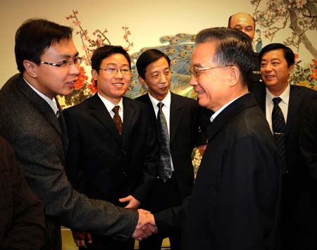 Chinese Premier Wen Jiabao (R, front) shakes hands with representatives of grass roots civilians attending the forum in Beijing, capital of China, on February 12, 2009.