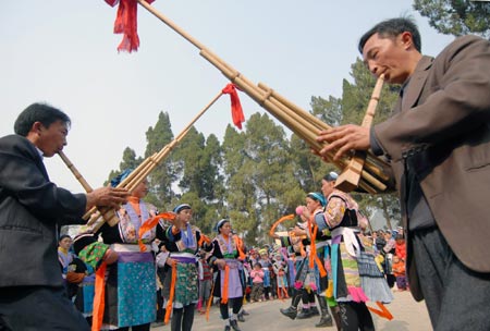 People of Miao ethnic group dance during a cultural activity held in Pingpo Village of Longli County, southwest China's Guizhou Province, on February 14, 2009.