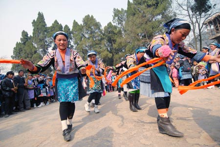 People of Miao ethnic group dance during a cultural activity held in Pingpo Village of Longli County, southwest China's Guizhou Province, on February 14, 2009.