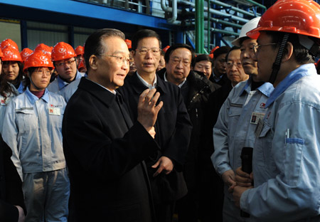 Chinese Premier Wen Jiabao (L Front) talks with workers as he visits an iron and steel factory in Tianjin, north China, on February 15, 2009. Premier Wen made an inspection tour in Tianjin on February 15-16. 
