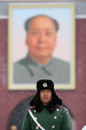 A Chinese armed police soldier stands guard on the Tian'anmen Square during a snowfall in Beijing on February 18, 2009. Rain and snowfall have helped ease a severe drought in northern and eastern China. 