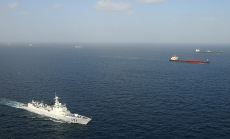 'Haikou' vessel of Chinese navy (front) escorts merchant vessels in the Gulf of Aden, on February 17, 2009. The Chinese naval fleet completed its 21th batch of escort missions against pirates on Wednesday. 