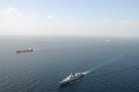 The 'Wuhan' vessel of the Chinese navy (Below) escorts merchant vessels in the Gulf of Aden, on February 17, 2009.